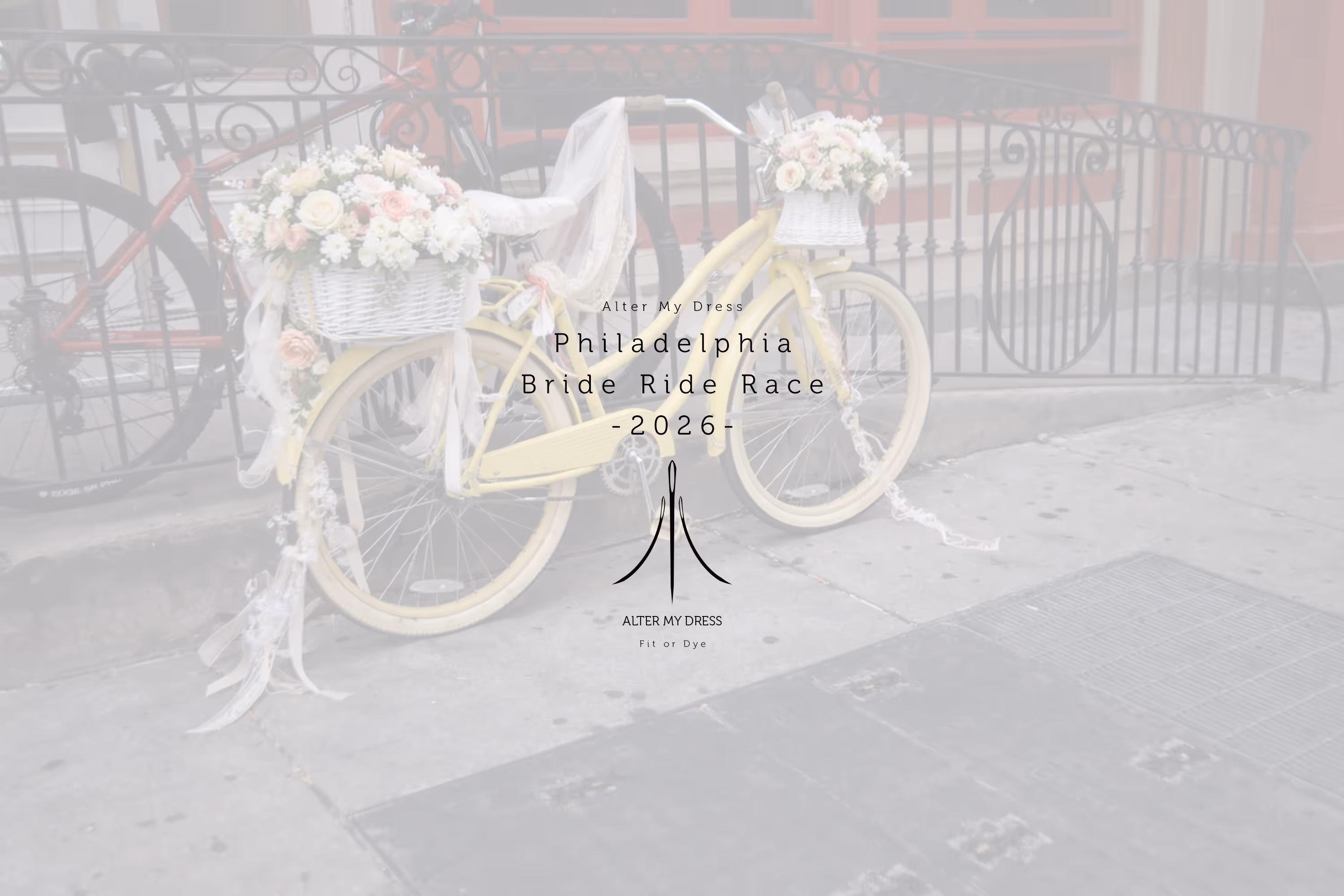 Yellow bicycle decorated with white and pink flowers in baskets, parked on a city sidewalk by a black wrought-iron fence.